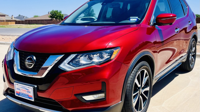 Red Nissan SUV at Hail Team One Auto Hail Repair Facility in Wolfforth Texas