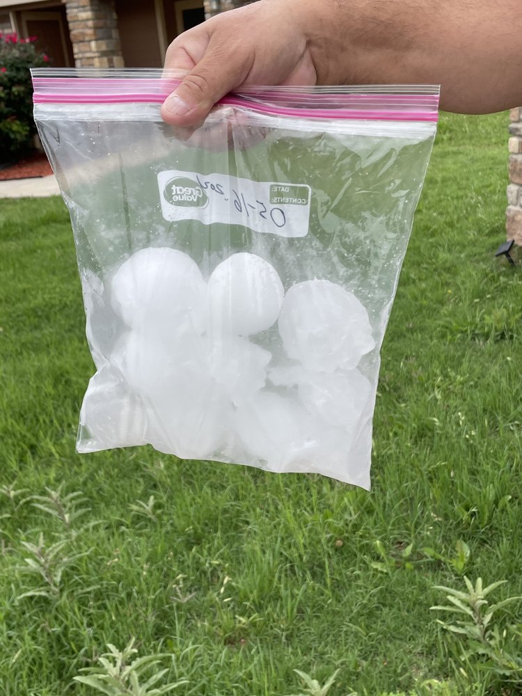 Man holding large hailstones after storm in Lubbock – Auto Hail Damage Evidence
