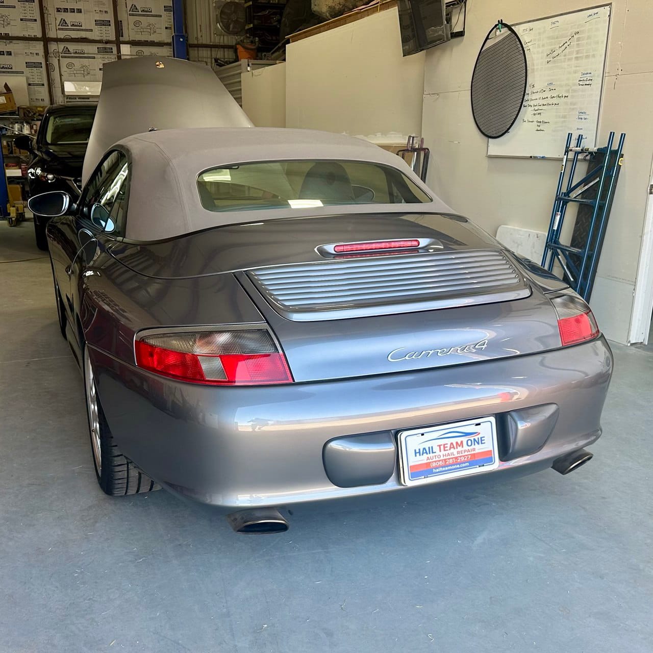 Porsche Carrera 4 in the Hail Team One repair shop in Lubbock Texas